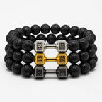 Volcanic stone bracelets set with black lava beads and gold silver dumbbell charms, stacked jewelry for bold gym style