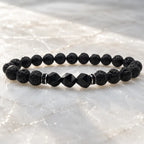 Volcanic stone bracelet on bright crystal with textured lava beads and black gemstone accents for clean energy