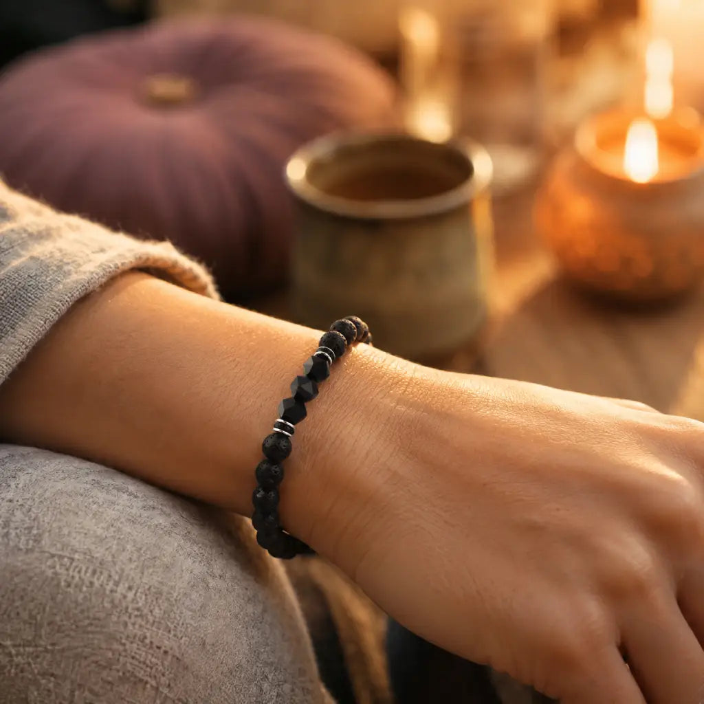 Volcanic stone bracelet worn on wrist with black lava beads and faceted accents for cozy wellness style daily comfort