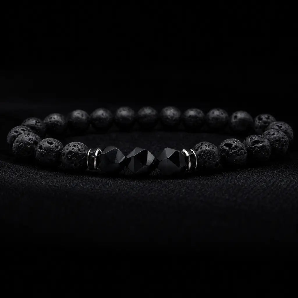 Volcanic stone bracelet on black velvet with lava beads, faceted center stones and silver spacers for luxe focus