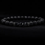 Volcanic stone bracelet on black velvet with lava beads, faceted center stones and silver spacers for luxe focus
