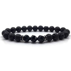 Volcanic stone bracelet with black lava beads, faceted accents and silver spacers for bold grounding style daily