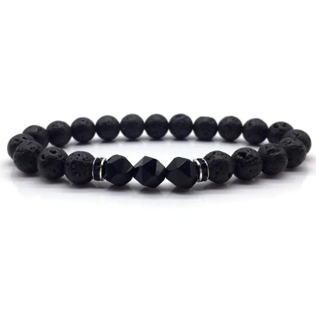Volcanic stone bracelet with black lava beads, faceted accents and silver spacers for bold grounding style daily