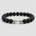 Volcanic stone bracelet with matte lava beads and silver dumbbell charm, minimalist fitness jewelry for daily durability