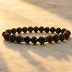 Volcanic stone bracelet on glowing marble with black lava beads and faceted accents for radiant everyday style