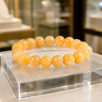 Yellow jade quartz bracelet with polished gemstone beads on luxury display, natural crystal jewelry for elegant style