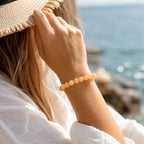 Yellow jade quartz bracelet worn near seaside with natural gemstone beads for stylish everyday elegance