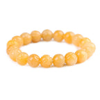 Yellow jade quartz bracelet isolated on white background with polished crystal beads for product clarity