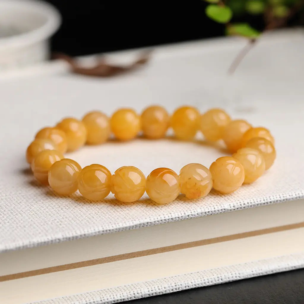 Yellow jade quartz bracelet with smooth gemstone beads and crystal jewelry styling for calming daily energy