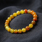 Yellow popcorn agate bracelet bright honey beads on dark fabric, warm crystal jewelry for confident everyday energy