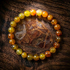 Yellow popcorn agate bracelet golden beads around polished stone on wood, earthy gemstone jewelry for meaningful gifting