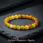 Yellow popcorn agate bracelet glowing yellow orange beads on black slate, bold crystal jewelry for standout gift appeal