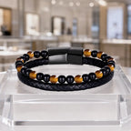 Yellow tiger eye bracelet with braided leather and polished gemstone beads in luxury jewelry display style