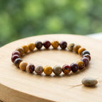Yolk Stone Bracelet on wooden surface with natural tones, stylish crystal jewelry enhancing grounding energy and balance