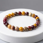 Yolk Stone Bracelet with multicolor polished beads on clean white surface, minimalist crystal jewelry for elegant everyday wear