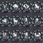 Zodiac bracelet collection with all twelve signs, blue-green jasper, matte black onyx, hematite spacers, and black zodiac centerpieces, shown in a full product view on dark fabric.